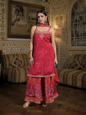 Rani HotPink embroidered kurta paired with ethnic floral motif printed sharara pants and a matching gold embellished dupatta. A vibrant, elegant choice for wedding ceremonies and festive celebrations.